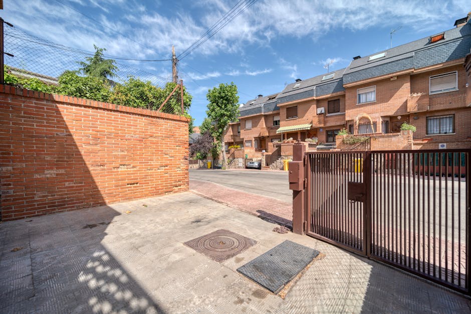Exterior entrance showing the brick wall and secure gate of the training center