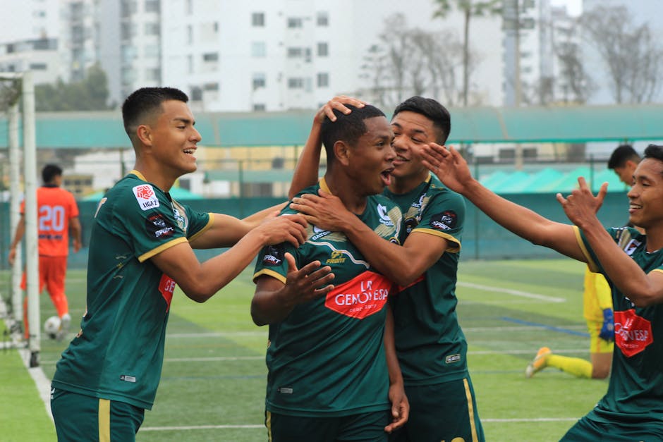 Soccer players celebrating a victory goal